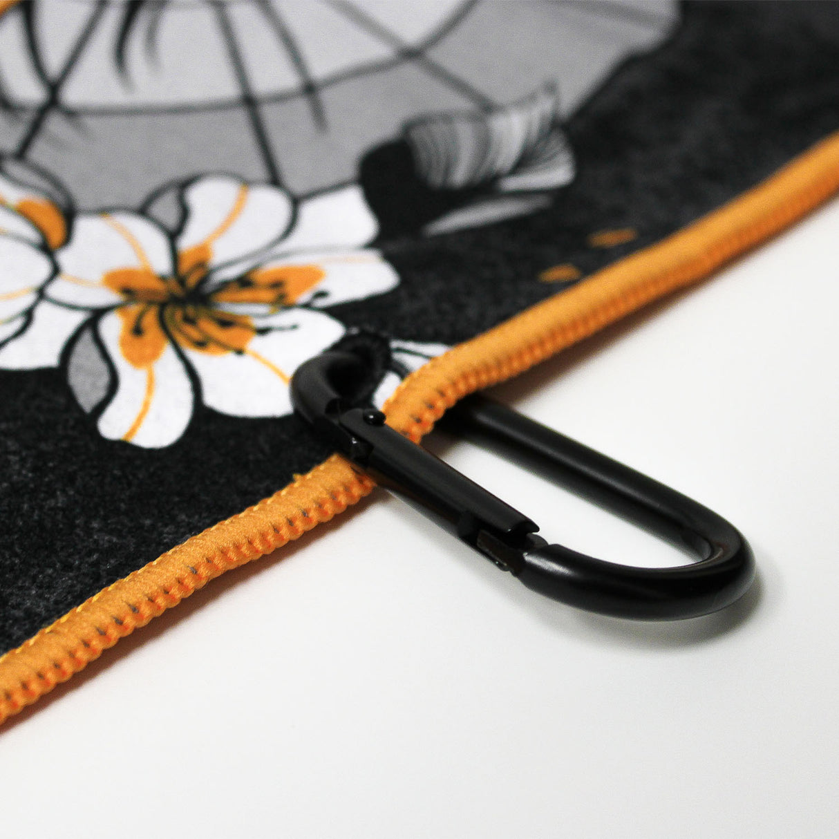 Close up of Utility Towel black carabiner clip with 'RokFit X Blondie' graphic