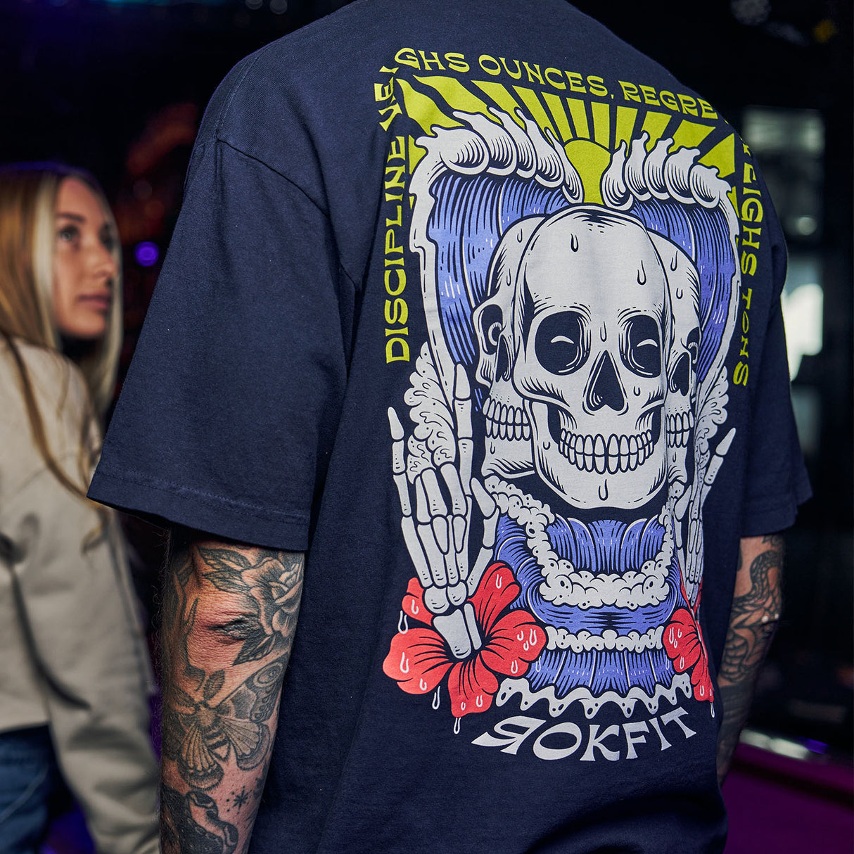 Male model in bar wearing navy blue Street Tee with 'Discipline Weighs Ounces, Regrets Weighs Tons' graphic