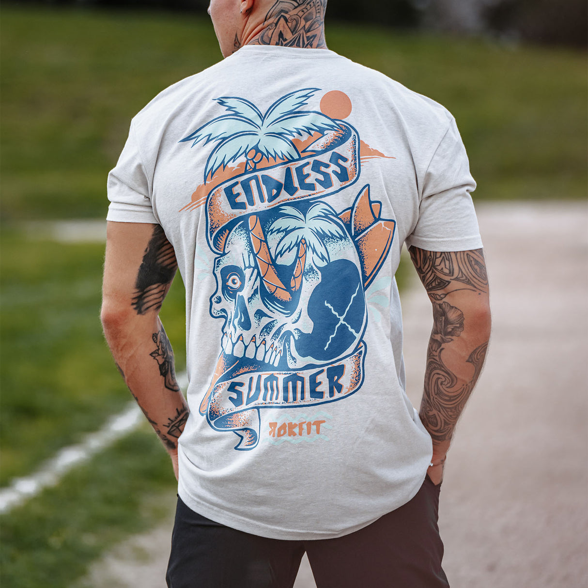 Male model outdoors wearing unisex Active Tee with 'Endless Summer' graphic