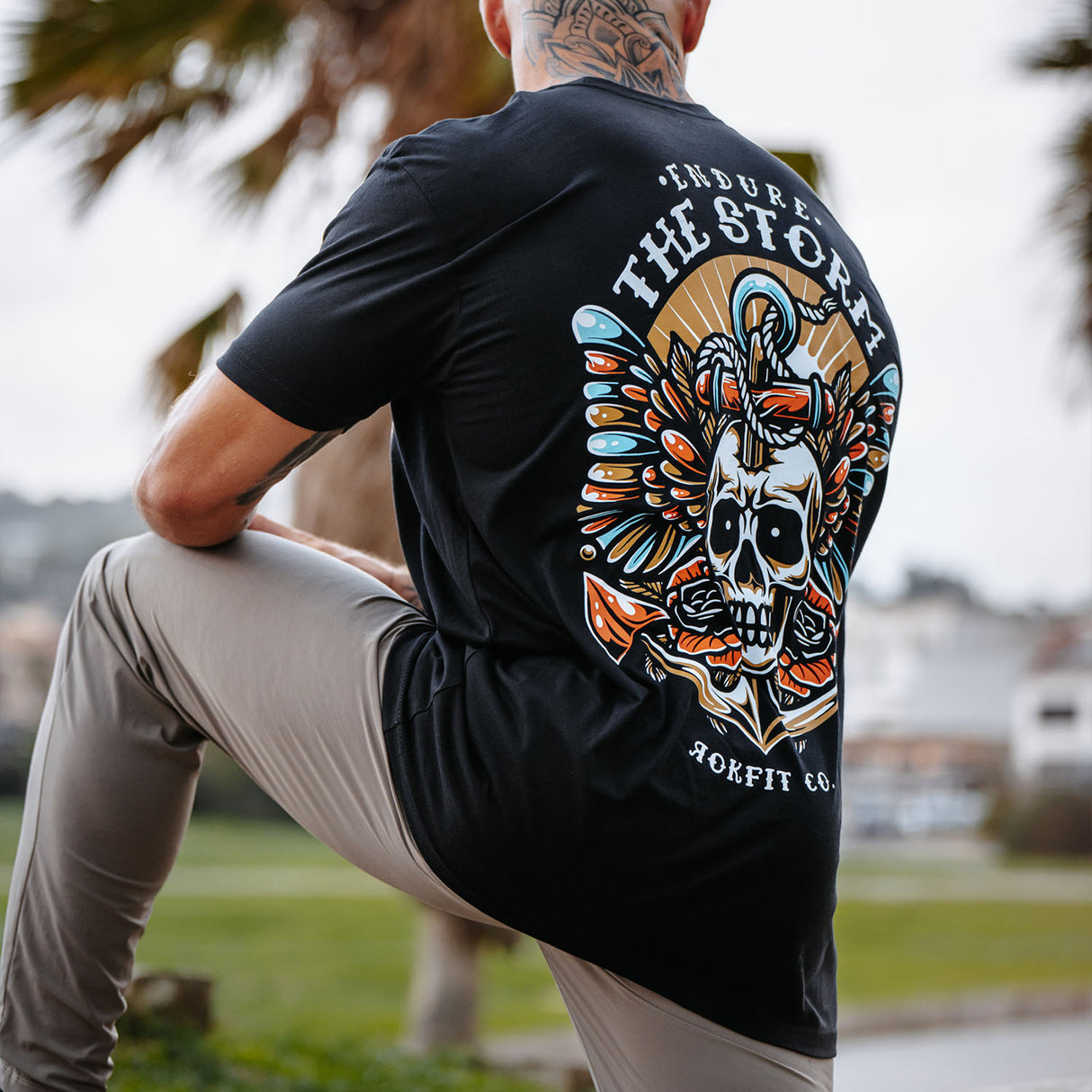 Male model outdoors wearing unisex Active Tee with 'Endure The Storm' graphic
