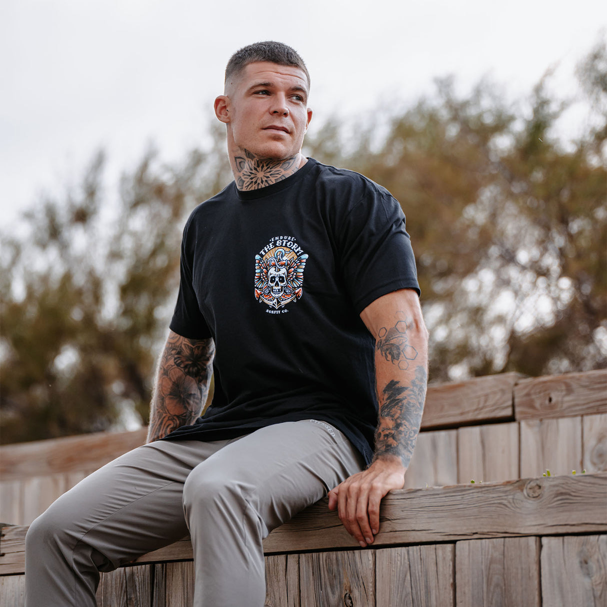Male model outdoors wearing unisex Active Tee with 'Endure The Storm' graphic