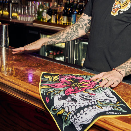 Male model using Utility Towel on bar top with 'Eternal Bloom' graphic