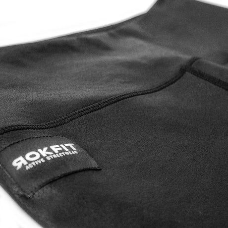 Close up view of women's black Night Out leggings showing logo